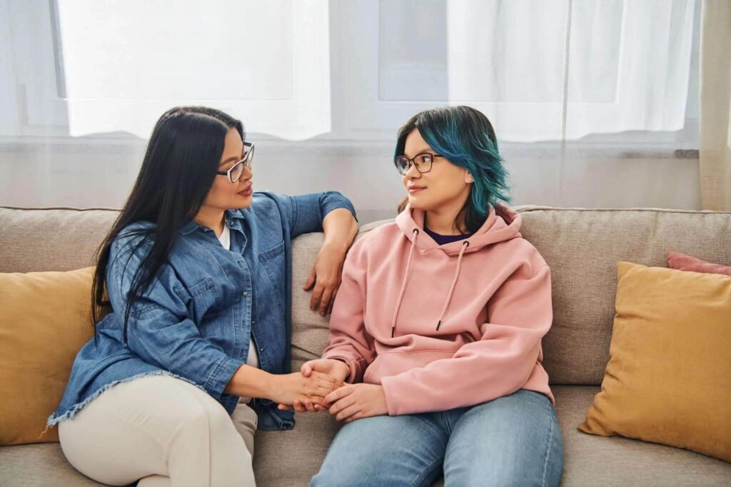 Parent having a supportive conversation with their teenager about therapy