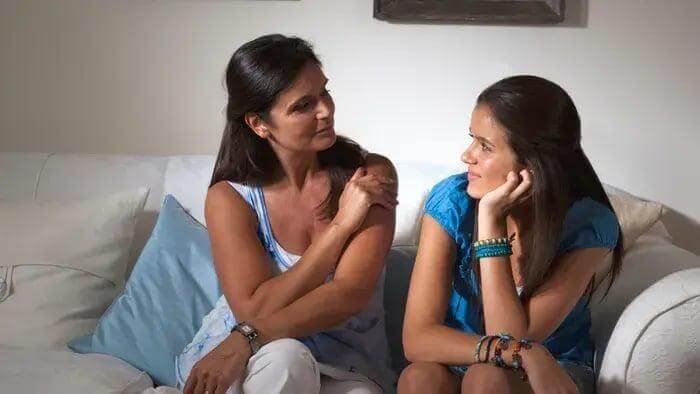 Parent supporting a teenager through emotional challenges