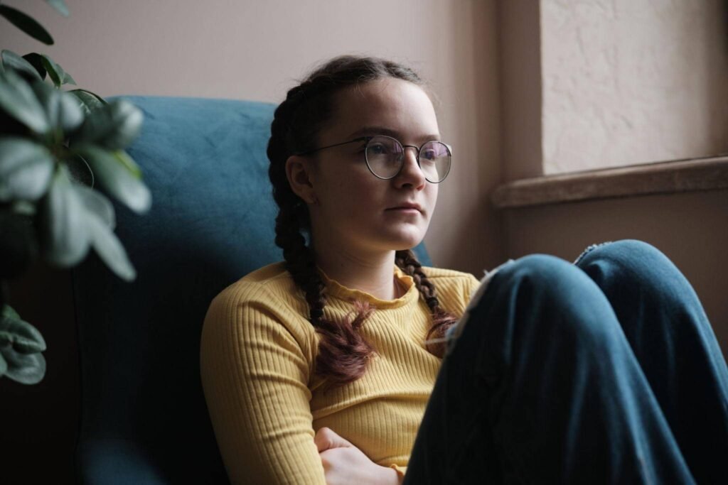Teenager showing signs of emotional distress and withdrawal