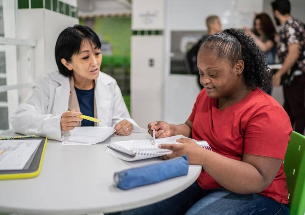 Individualised Behaviour Support Practitioner and caregiver discussing an individualised support approach Image title: Individualised Behaviour Support