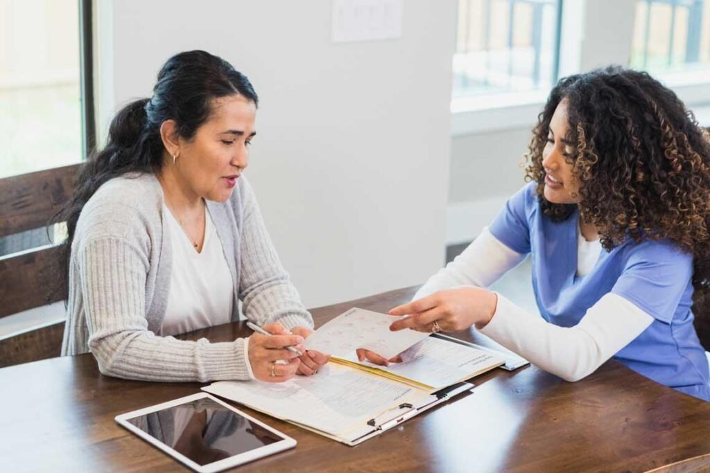 Positive Behaviour Support for NDIS Participants Allied health professional discussing support with an adult with disability